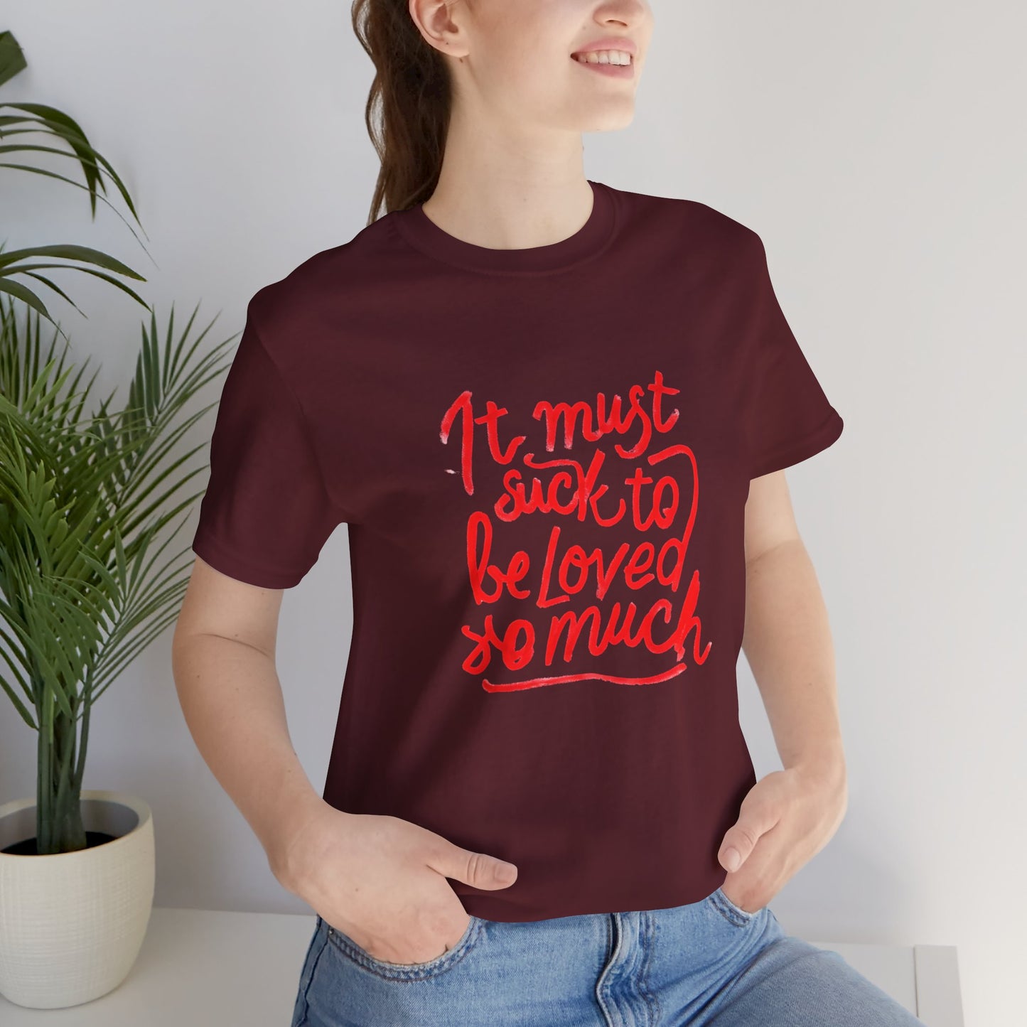 T‑Shirt — “It Must Suck to Be Loved So Much” Red Script Tee