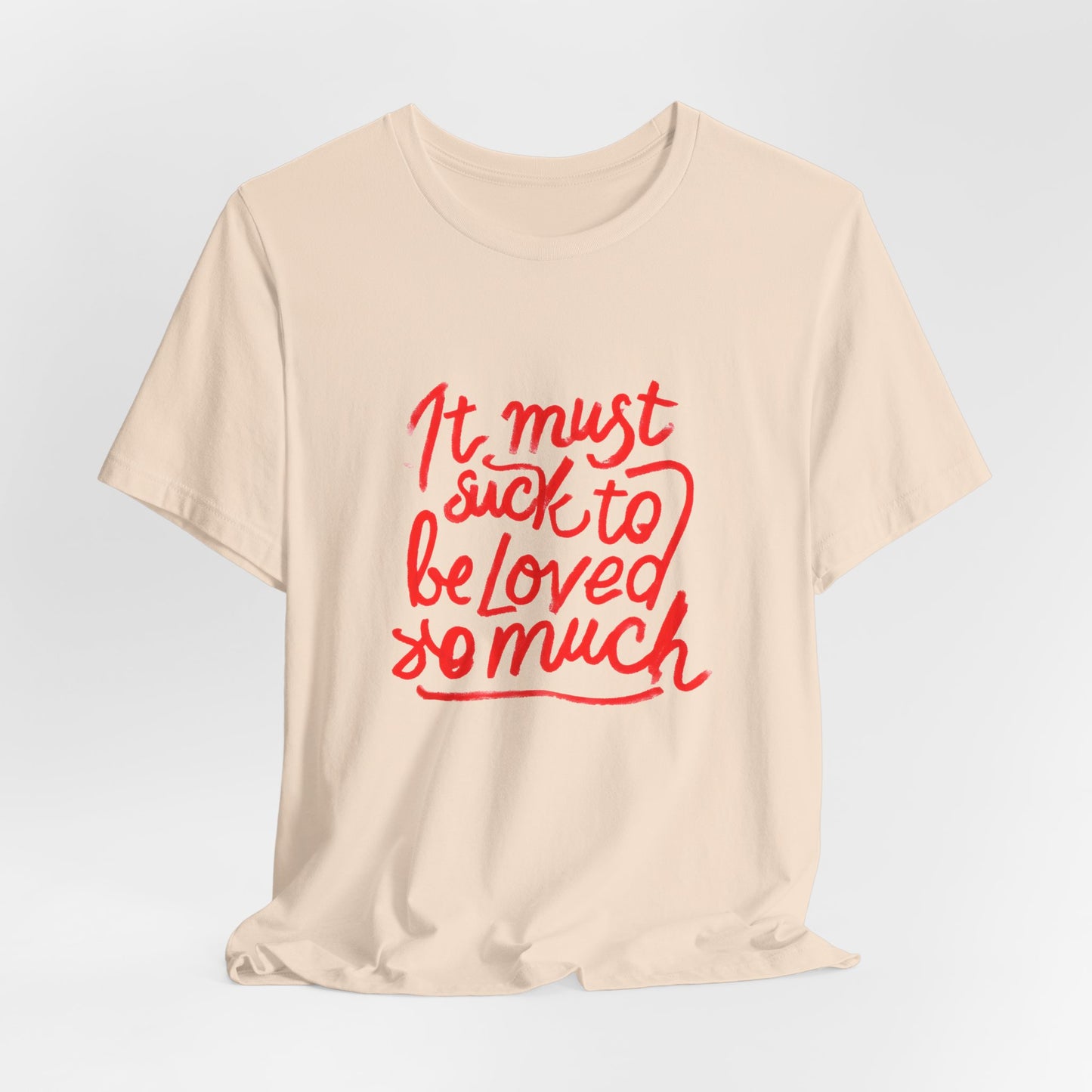 T‑Shirt — “It Must Suck to Be Loved So Much” Red Script Tee