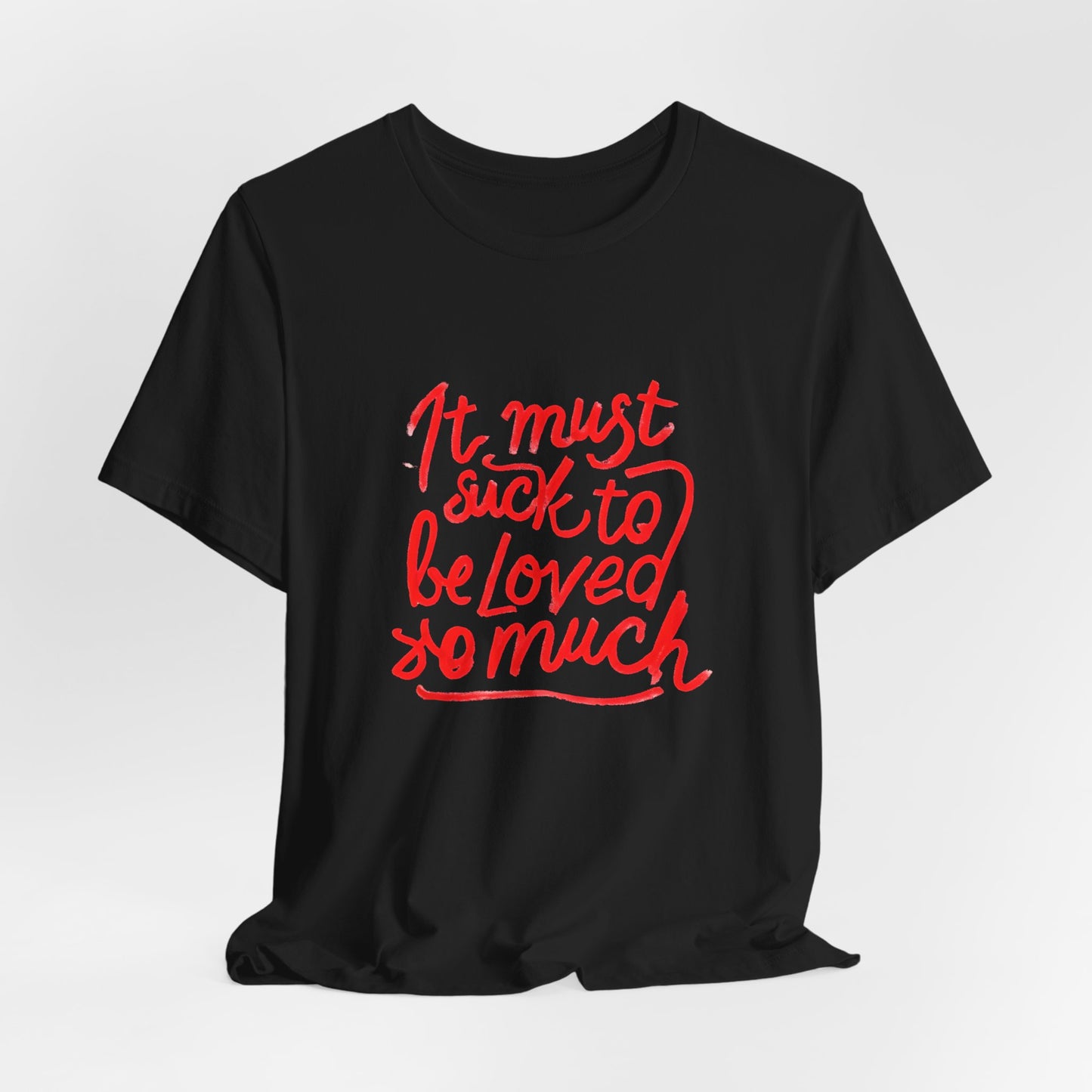T‑Shirt — “It Must Suck to Be Loved So Much” Red Script Tee