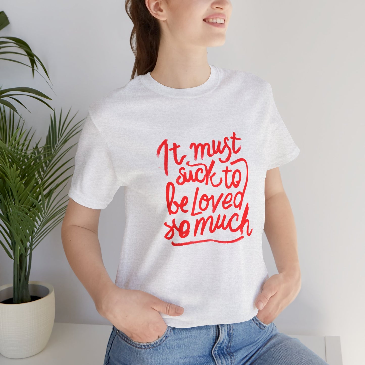 T‑Shirt — “It Must Suck to Be Loved So Much” Red Script Tee