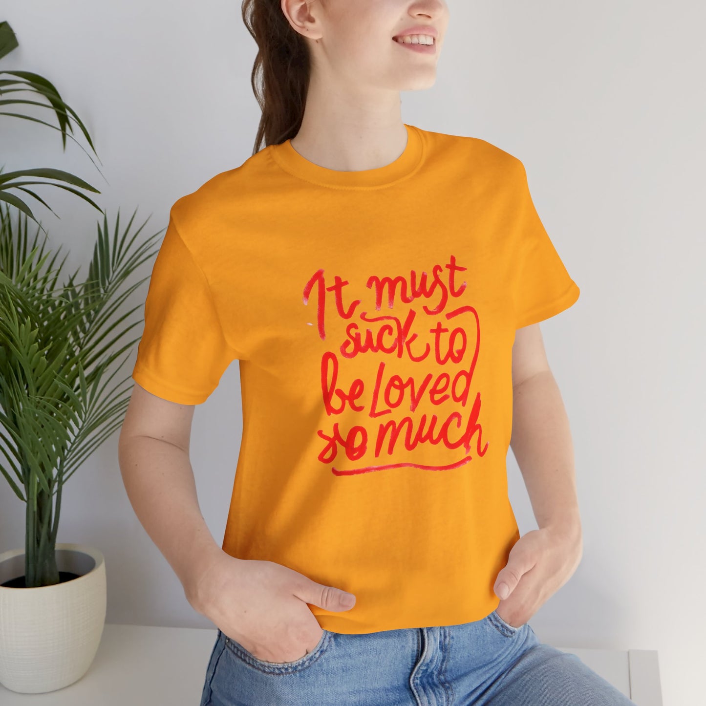 T‑Shirt — “It Must Suck to Be Loved So Much” Red Script Tee