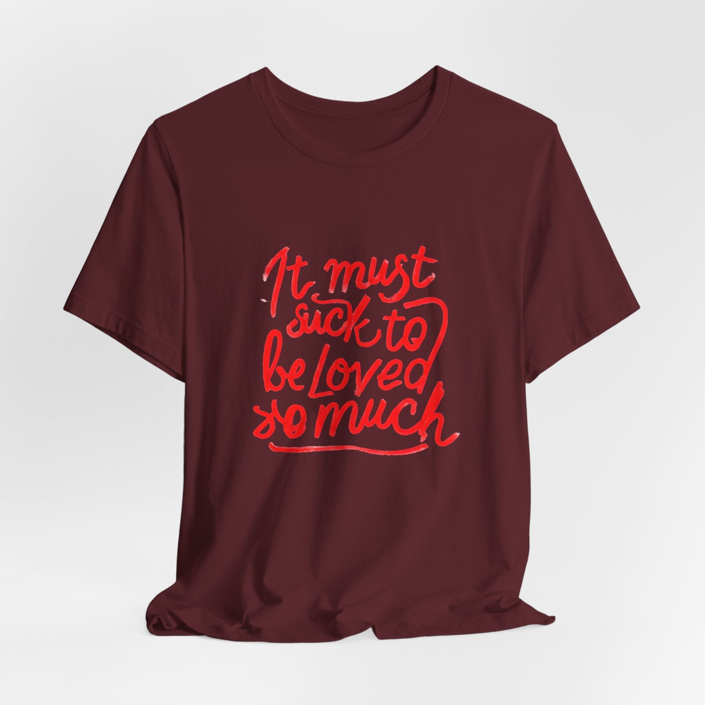 T‑Shirt — “It Must Suck to Be Loved So Much” Red Script Tee